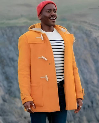 The Mid-Length Monty Duffle Coat in yellow, worn on location in Doctor Who